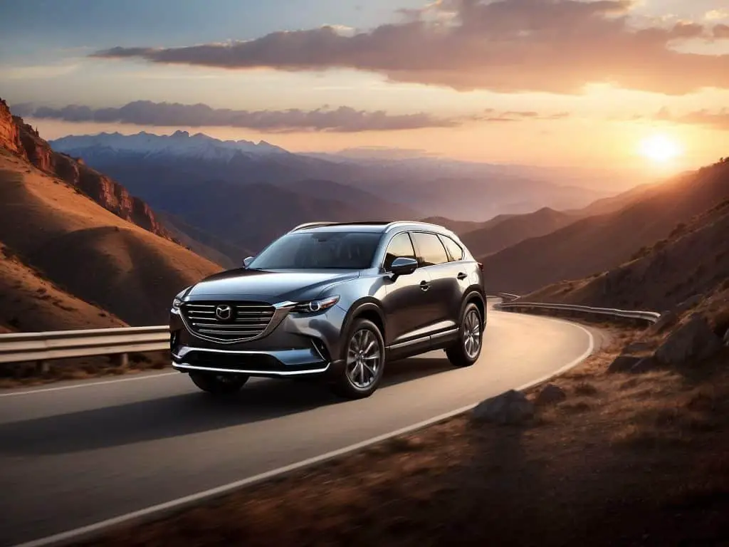 A Mazda CX-9 driving on a mountain road during sunset, highlighting its dynamic handling and the beautiful scenery in the background.